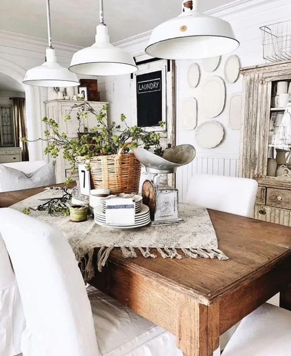 a wooden table topped with lots of white furniture