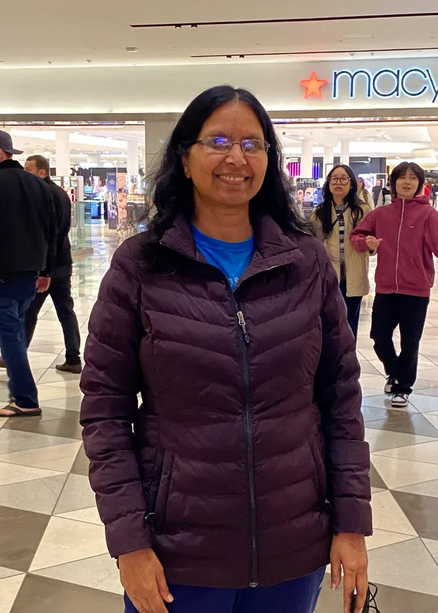 a woman standing in front of a macy's store