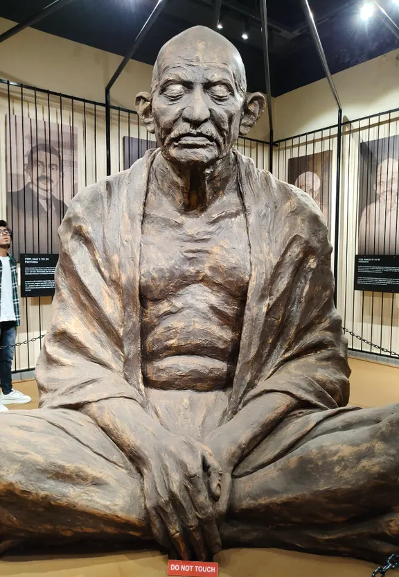 a statue of a man sitting in a room