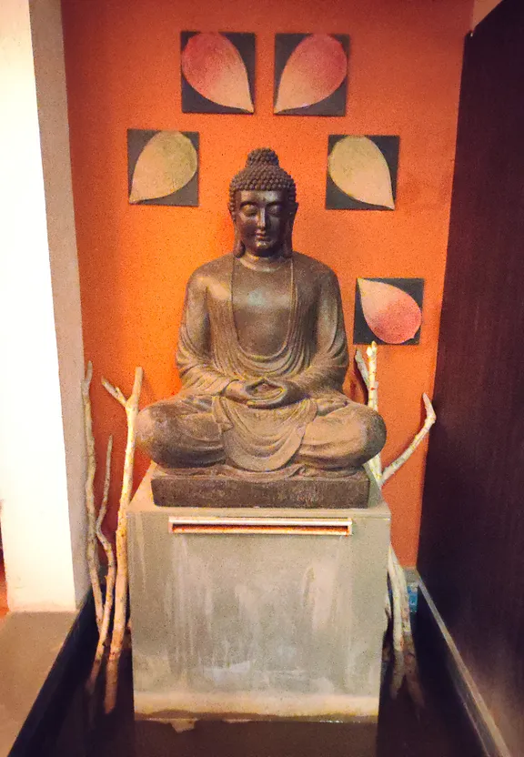 A small Buddha statue sits in a corner of a room. make the statue smaller, and place it in a more interesting location.