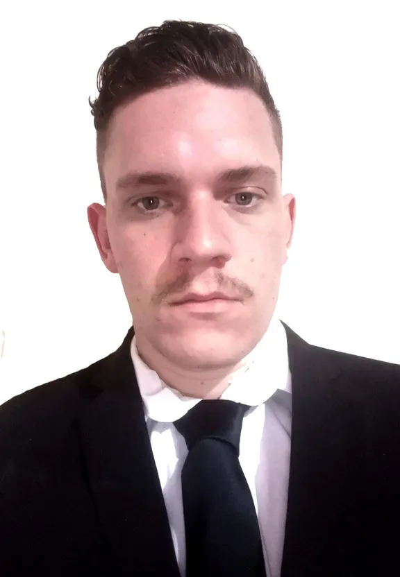 a man in a suit and tie posing for a picture
