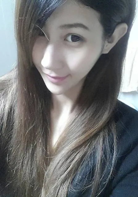 a woman with long hair is taking a selfie