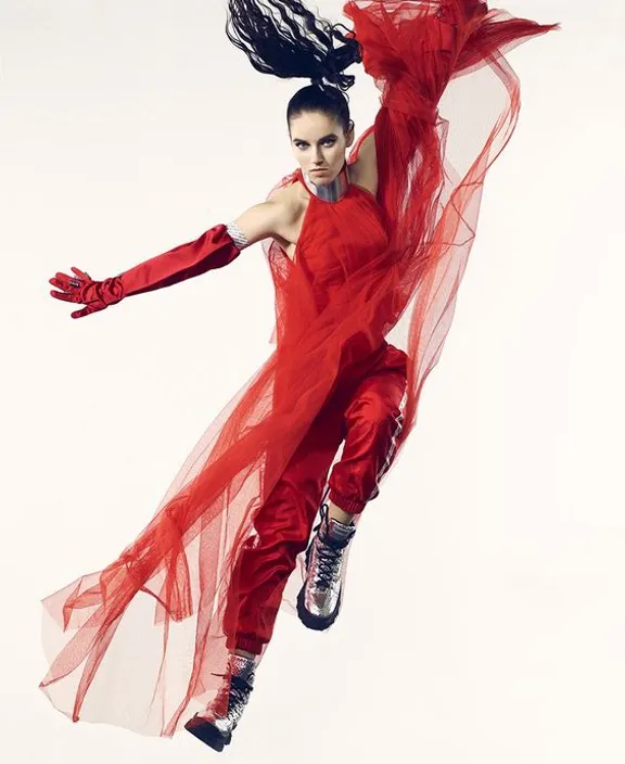 a woman in a red dress flying through the air