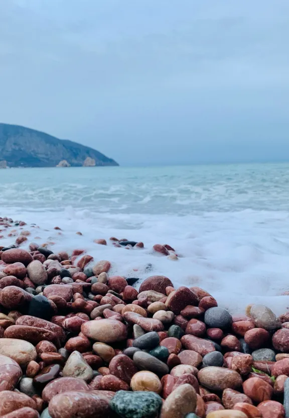 a bunch of rocks that are by the water