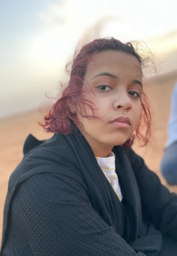 a woman with red hair standing up