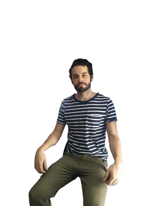 a man with a beard sitting on a stool