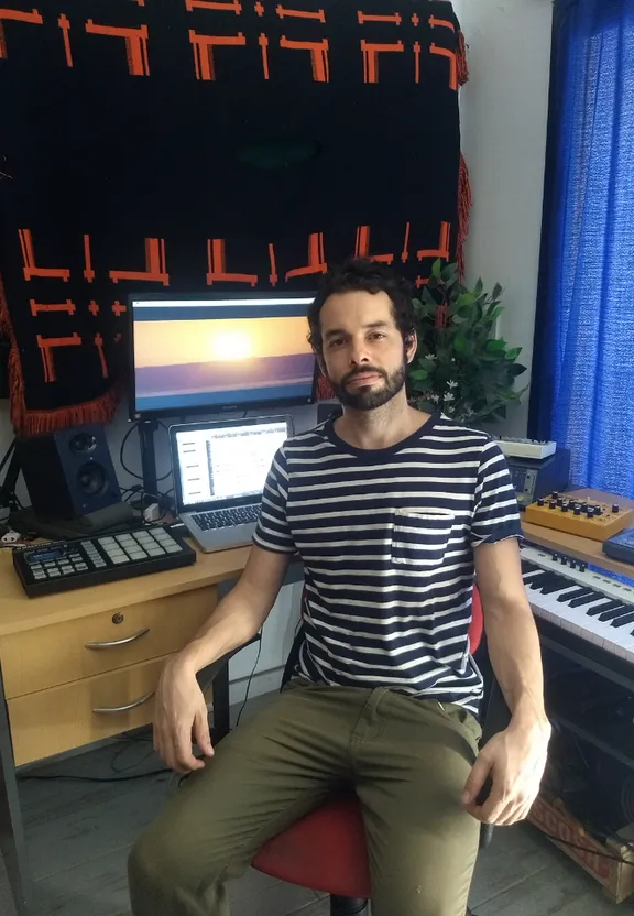 a man sitting in a chair in front of a keyboard