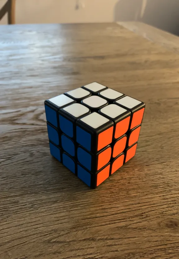 a rubik cube sitting on top of a wooden table