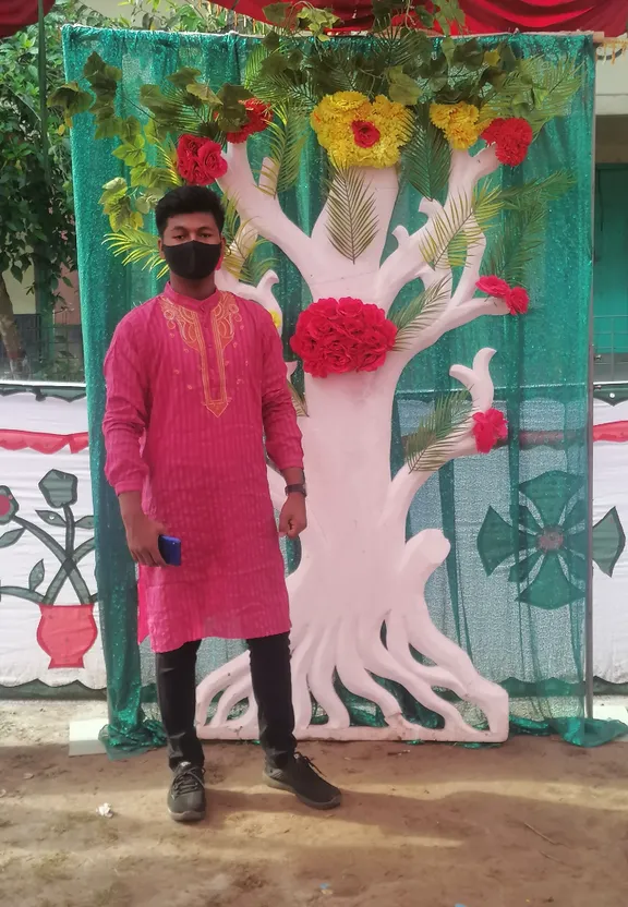 a man standing in front of a flower display