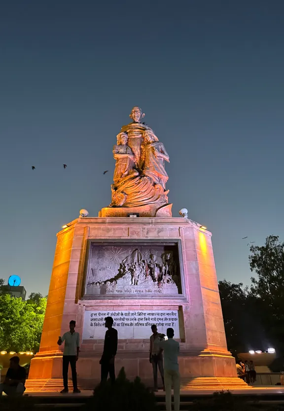 a group of people standing in front of a statue