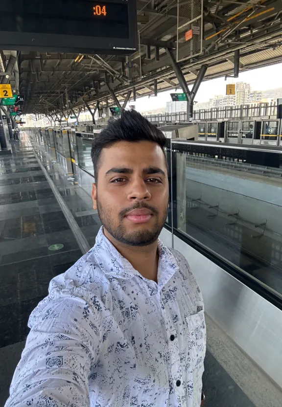 a man taking a selfie in a train station