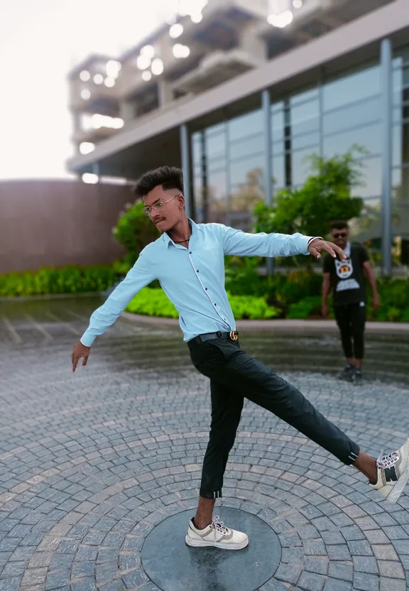 a man in a blue shirt and black pants is dancing