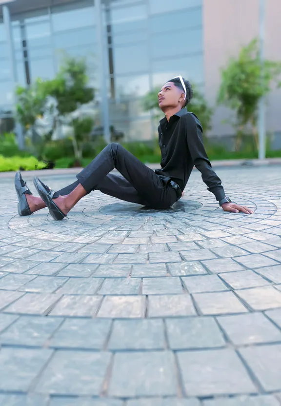 a man sitting on the ground with his legs crossed