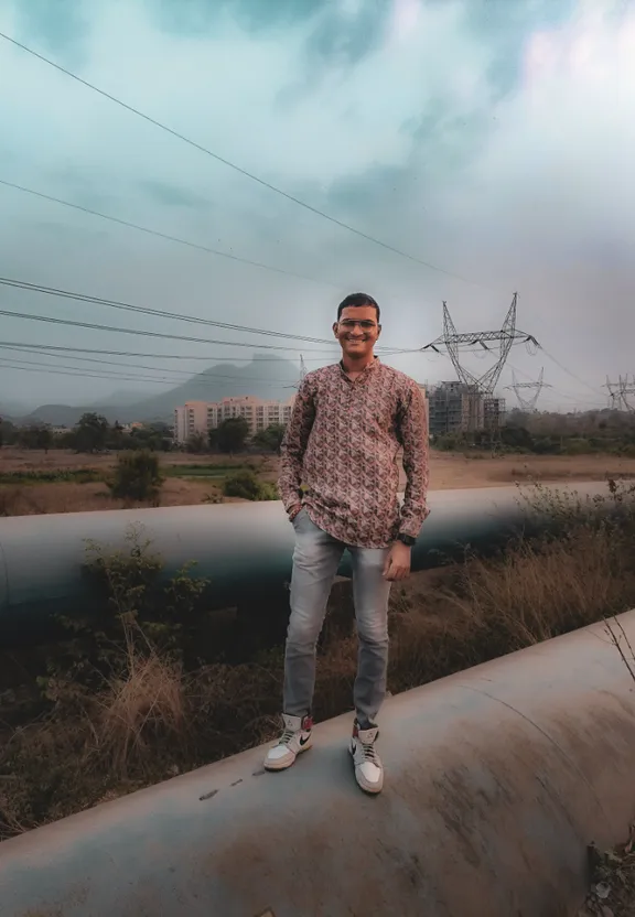 a man standing on top of a metal pipe