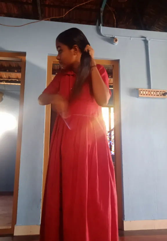 a woman in a red dress standing in a room