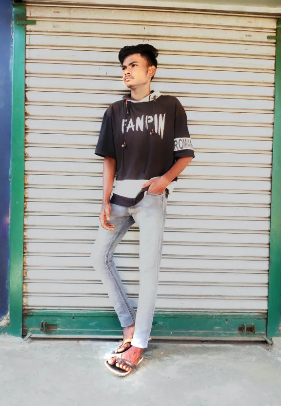 a young man standing in front of a garage door