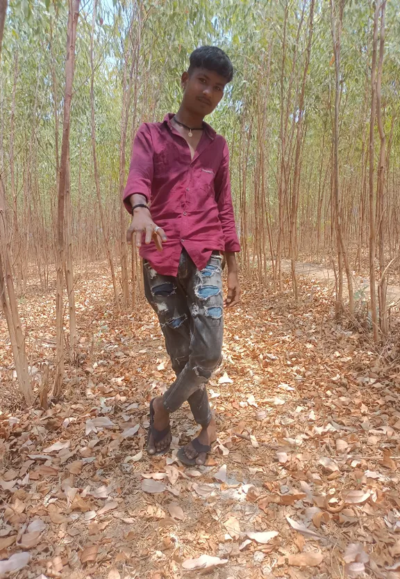 a man standing in the middle of a forest