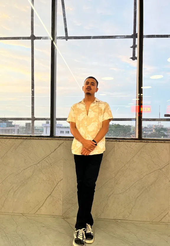 A man in front of a large window, with a cool look and a moving sky in different aesthetic view. Turn the man in so many cool looks and moving sky in different aesthetic view