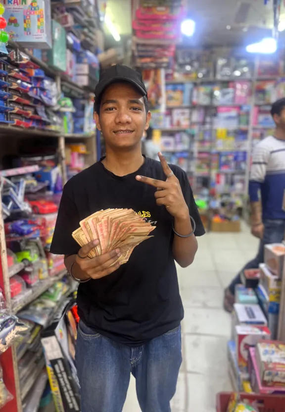 a man holding a bundle of money in a casino. change the store to a casino