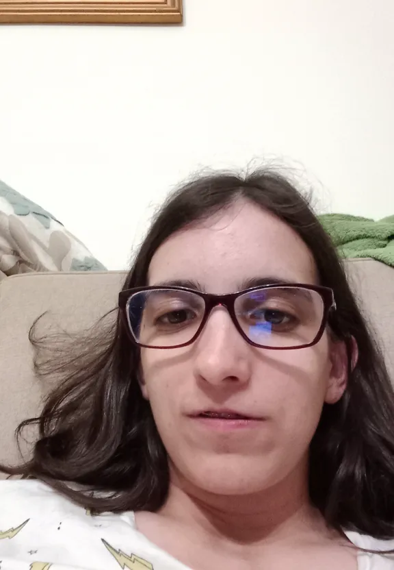 a woman with glasses sitting on a couch