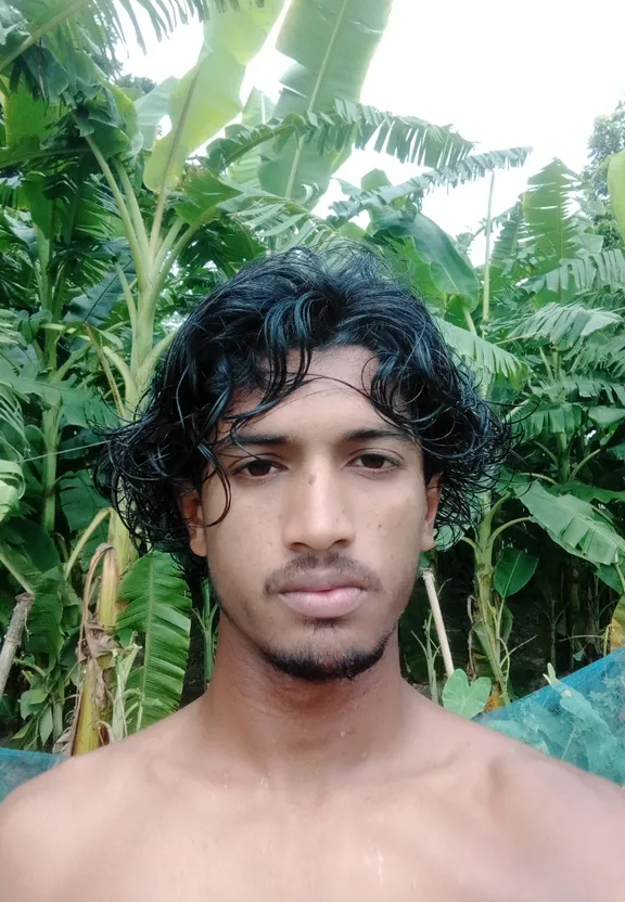 a man standing in front of a lush green forest