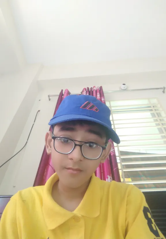 a young boy wearing a blue hat and glasses