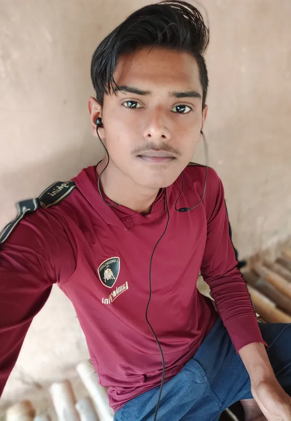 a young man wearing a red shirt and headphones