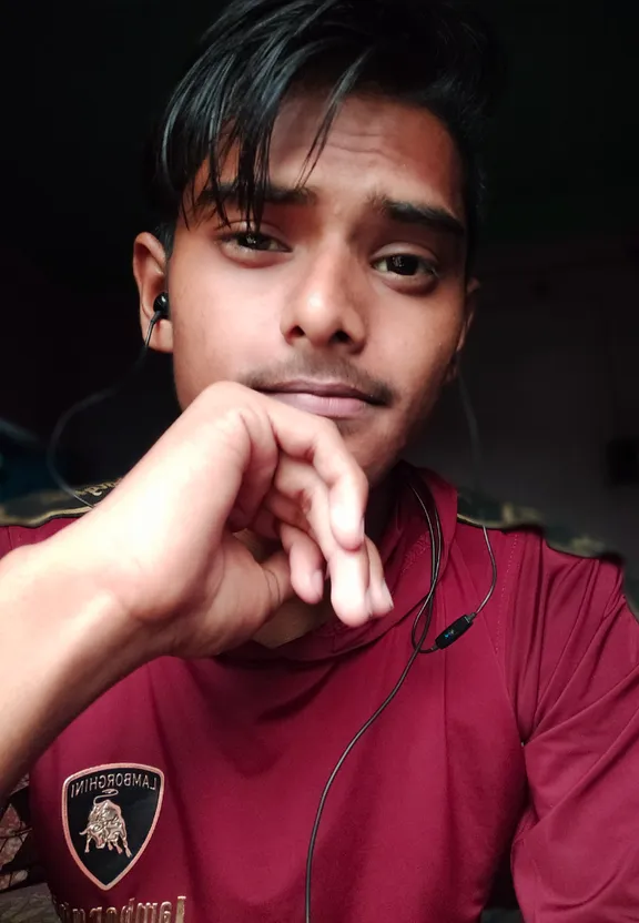 a man with ear buds and a red shirt