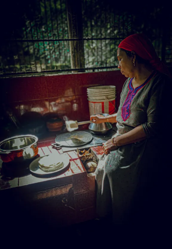 a woman standing in a kitchen next to a stove