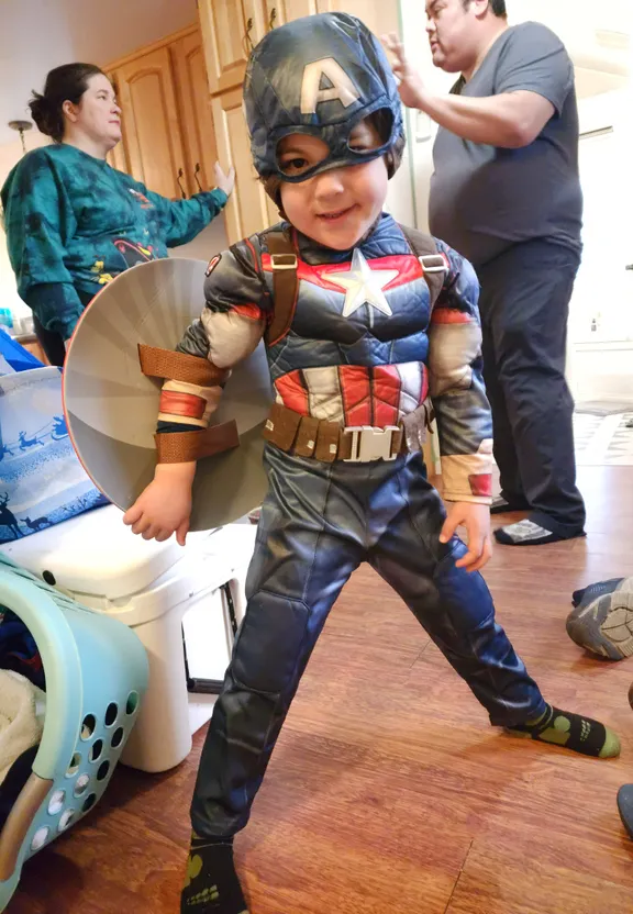 a young boy in a captain america costume