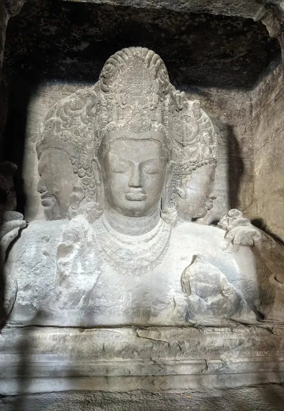 a statue of a buddha in a cave