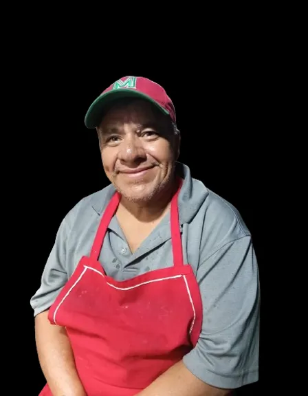 a man wearing an apron and a hat