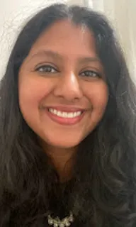 a woman with long hair smiling at the camera