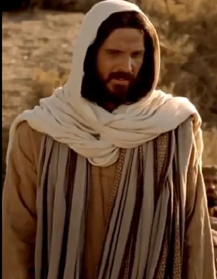 a man with a beard wearing a brown and white robe