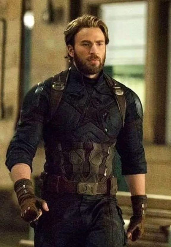 a man with a beard wearing a black suit