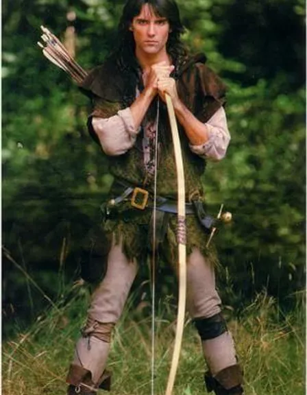a man in a costume holding a bow and arrow