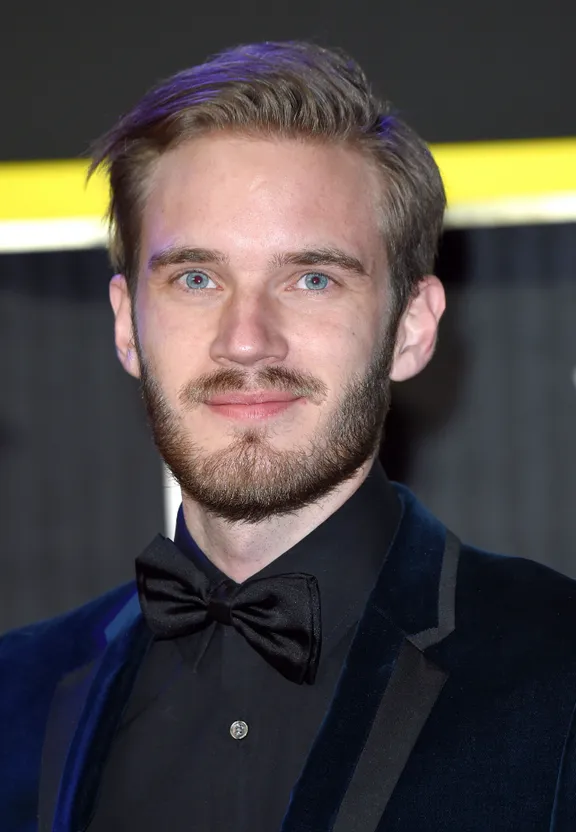 a man with a beard wearing a black suit and bow tie