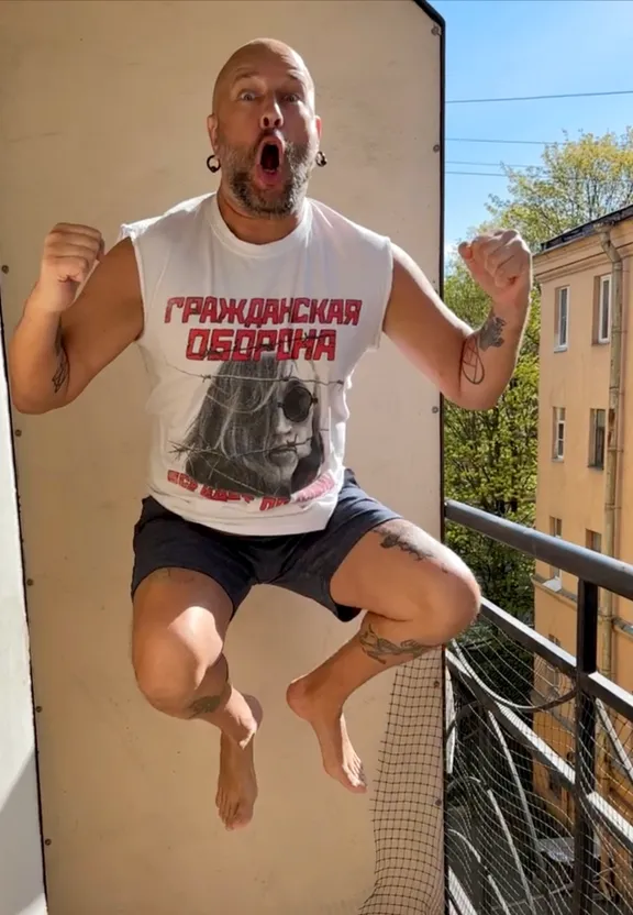 a man is jumping in the air on a balcony