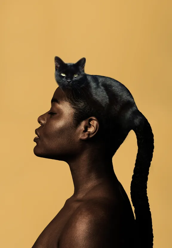 a woman with a black cat on her head