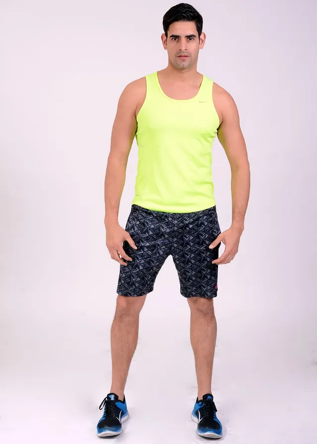 a man in a yellow tank top and black shorts