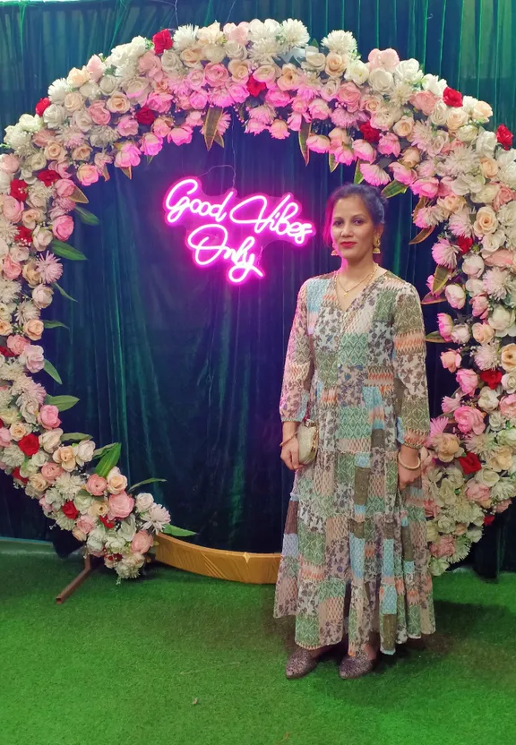 a woman standing in front of a floral display