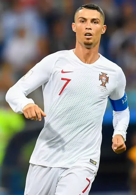 a male soccer player in a white uniform