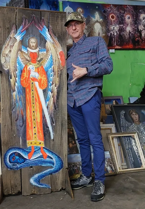 a man standing next to a painting of an angel