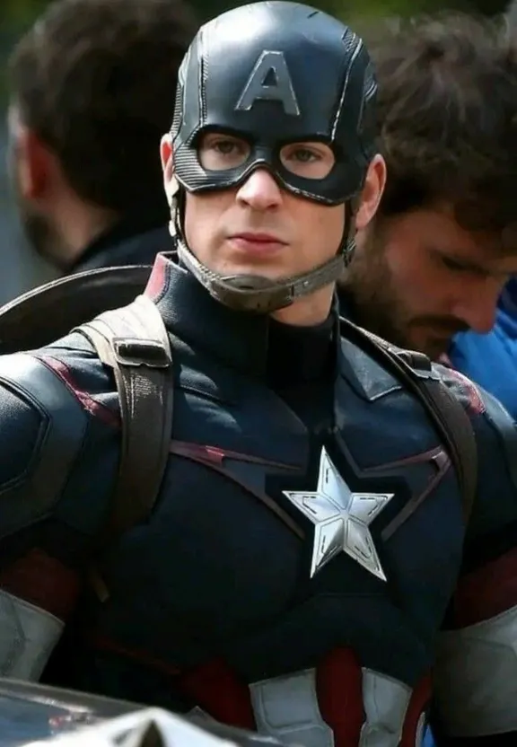 a man in a captain america costume standing next to another man