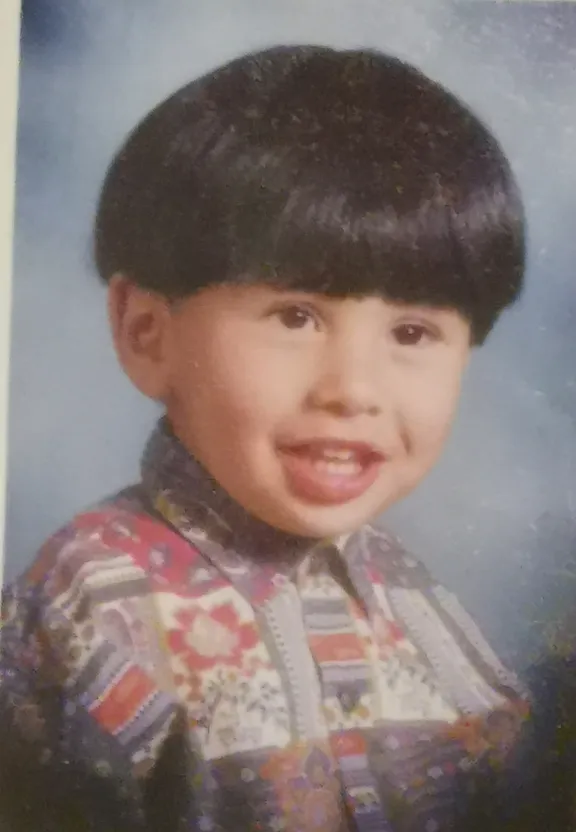 a picture of a young boy with a smile on his face