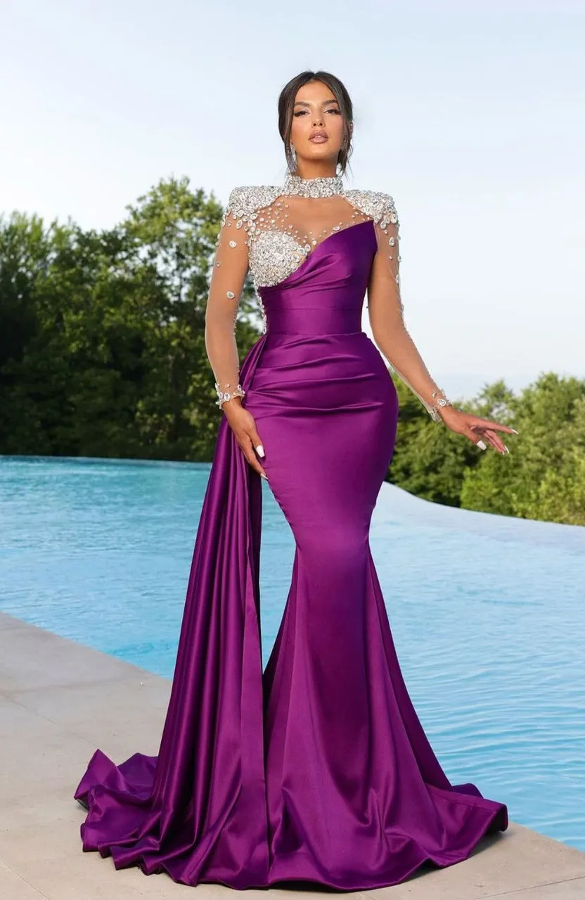 a woman in a purple dress standing by a pool