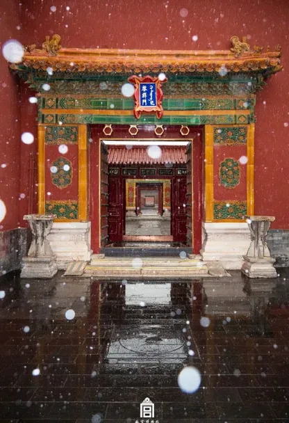 a red and yellow building with snow falling on it. building, world, architecture, chinese architecture, temple, snow, symmetry, art, event, winter