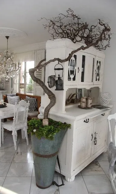 A Dining Room with a Tree in the Center of the Room, illuminated by Autumn Leaves. add a garland of autumn leaves around the tree