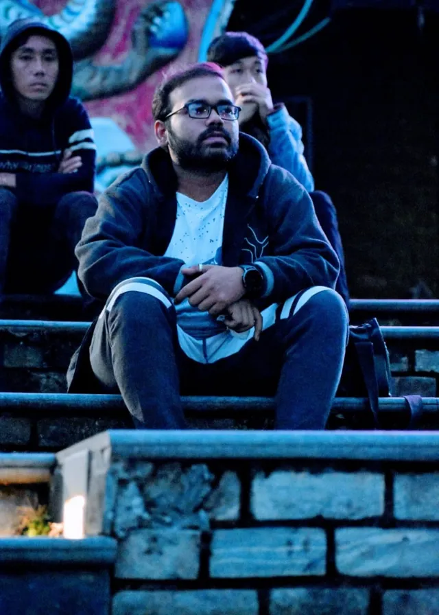 a group of people sitting on the bleachers