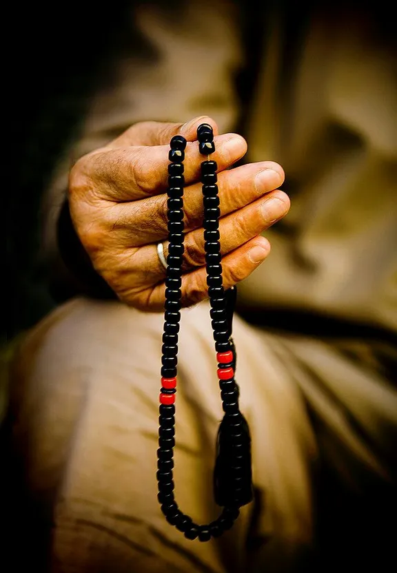 a person holding a rosary in their hands